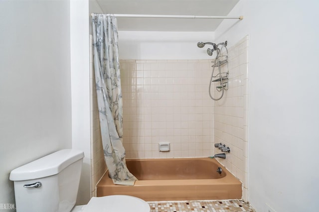 bathroom featuring shower / bath combination with curtain and toilet