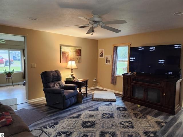 living room featuring hardwood / wood-style flooring and ceiling fan