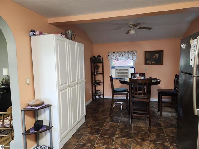 dining space with ceiling fan and lofted ceiling