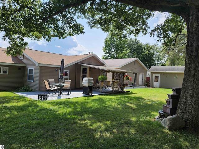 back of house featuring a yard and a patio area