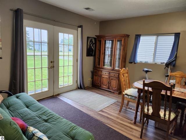 dining room featuring hardwood / wood-style floors and french doors