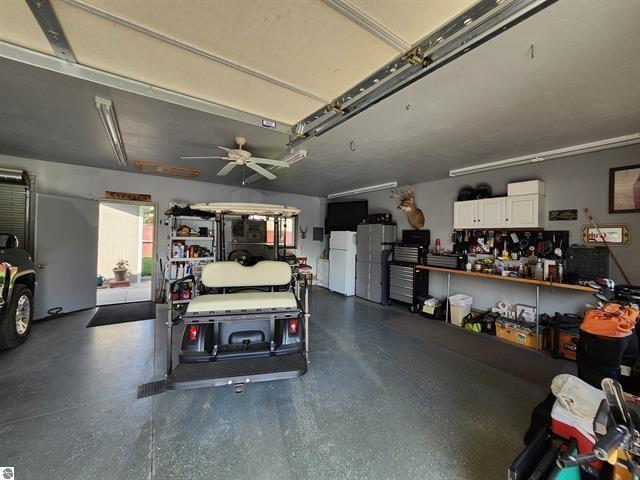 garage with white refrigerator and ceiling fan