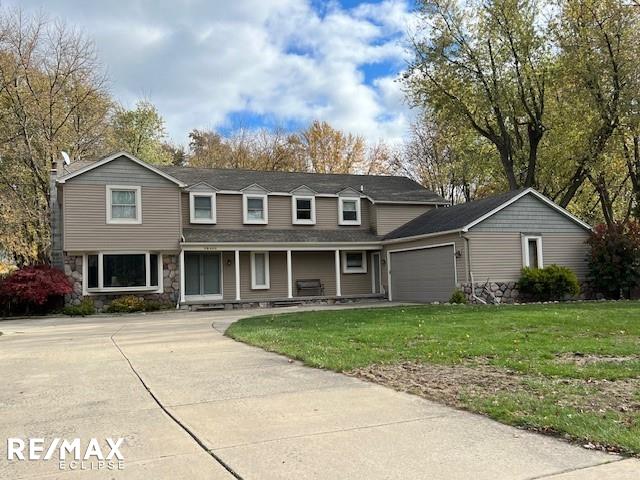 front of property with a garage and a front yard