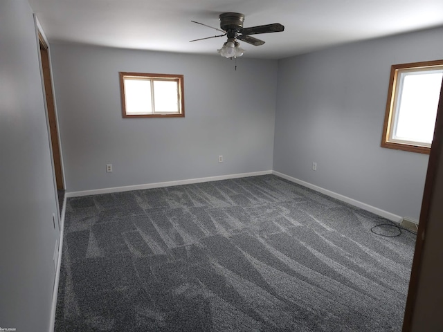 carpeted spare room with ceiling fan