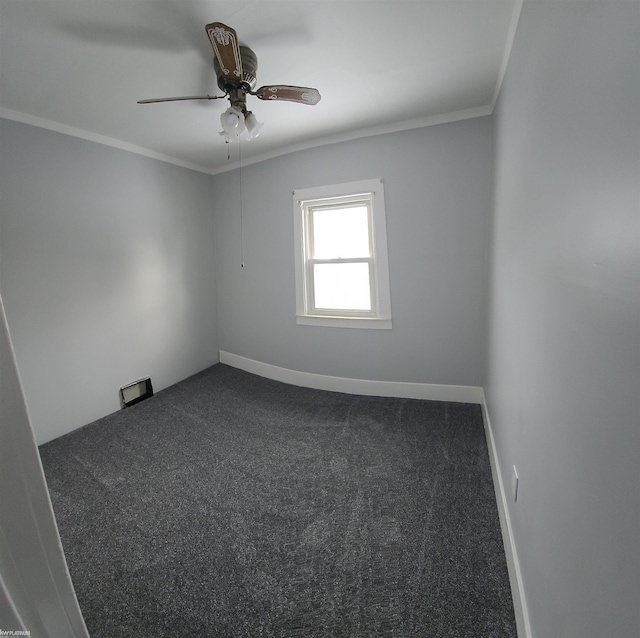 carpeted spare room with ceiling fan and ornamental molding