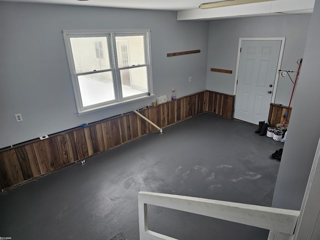 unfurnished room with wood walls