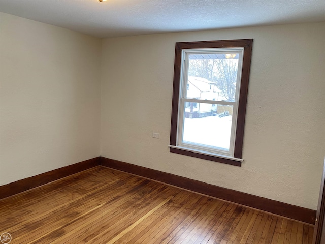 unfurnished room with wood-type flooring