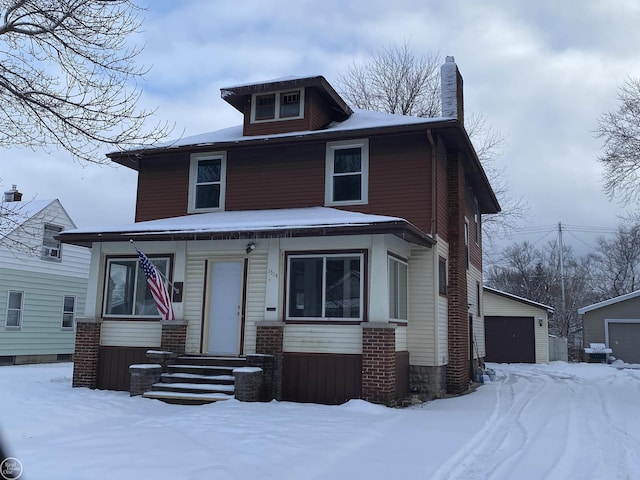 view of front facade with an outbuilding and a garage