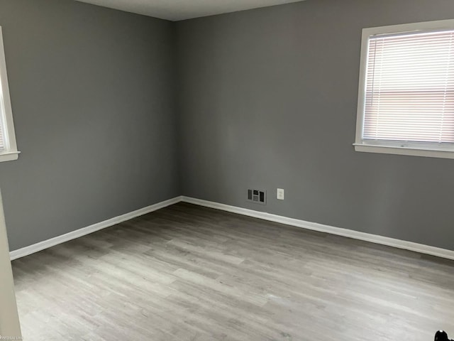 unfurnished room with light hardwood / wood-style floors