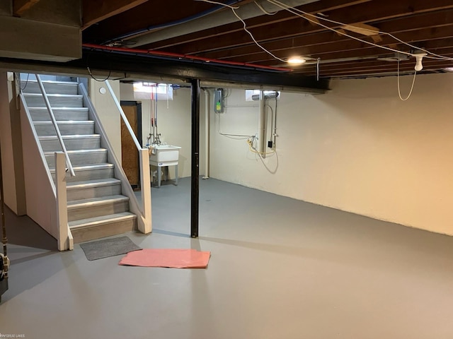 basement featuring sink and electric panel