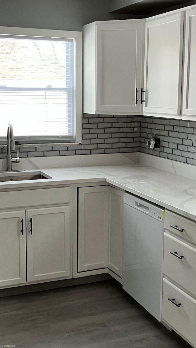 kitchen with white cabinetry, sink, backsplash, and dishwasher