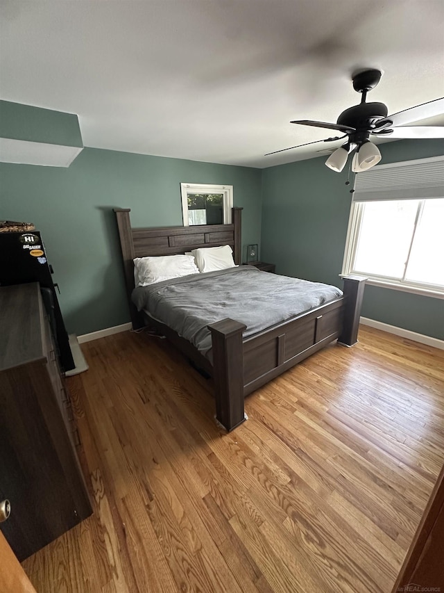 bedroom with ceiling fan and light wood-type flooring