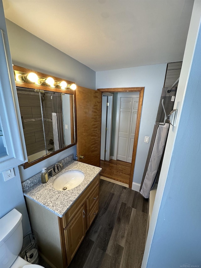 bathroom featuring hardwood / wood-style flooring, vanity, and toilet