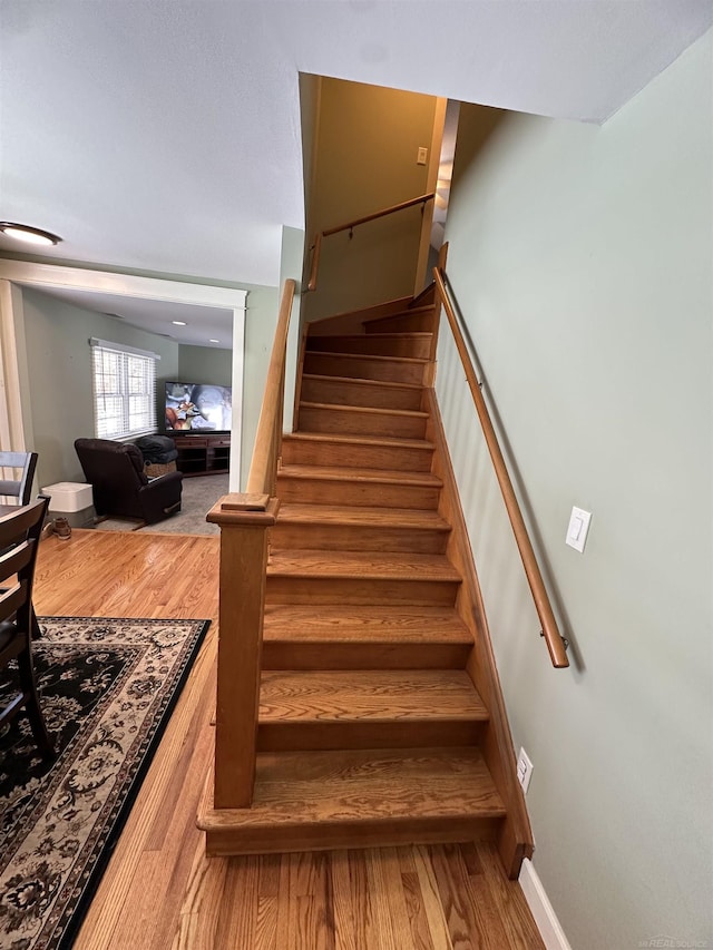 stairway with hardwood / wood-style floors