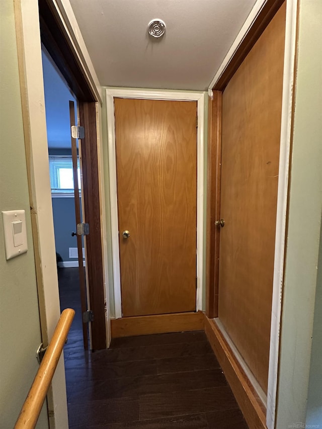 hallway with dark hardwood / wood-style floors