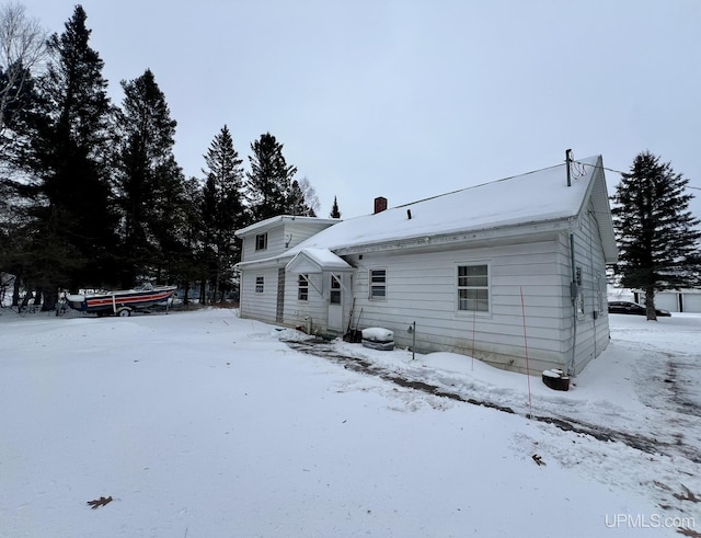 view of snow covered rear of property