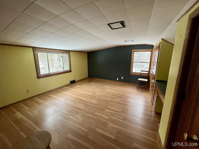 empty room featuring lofted ceiling and light wood-type flooring