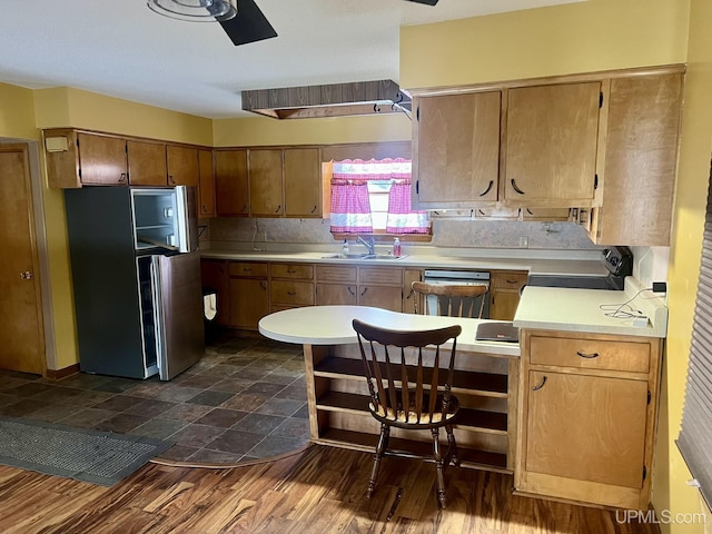 kitchen featuring sink, ceiling fan, backsplash, stainless steel appliances, and dark hardwood / wood-style floors