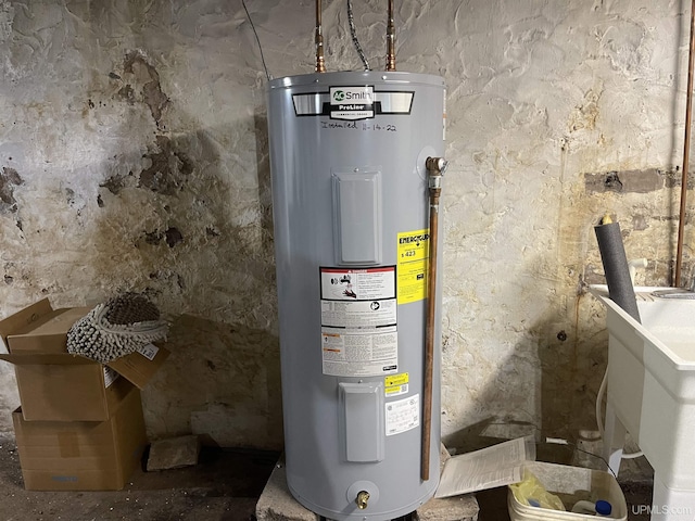 utility room with sink and water heater