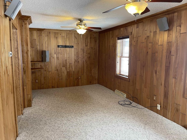 unfurnished room with light carpet, wooden walls, and a textured ceiling