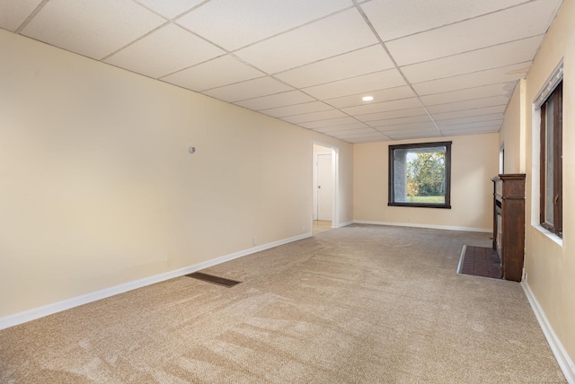 unfurnished room with carpet flooring and a paneled ceiling