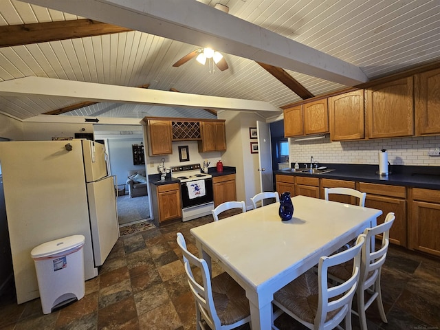 kitchen featuring lofted ceiling with beams, sink, backsplash, ceiling fan, and white appliances