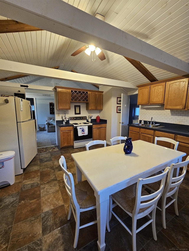 dining room with sink, beam ceiling, wooden ceiling, and ceiling fan