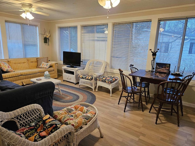 living room with crown molding, ceiling fan, and light hardwood / wood-style flooring