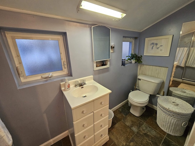 bathroom with vanity, toilet, and vaulted ceiling