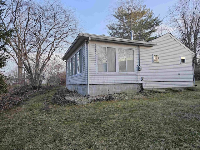 view of home's exterior with a yard