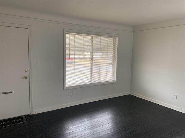 empty room with dark wood-type flooring