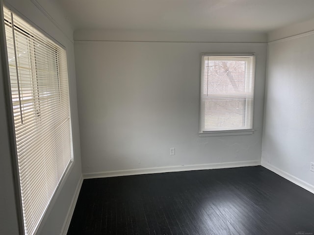 empty room with dark hardwood / wood-style floors