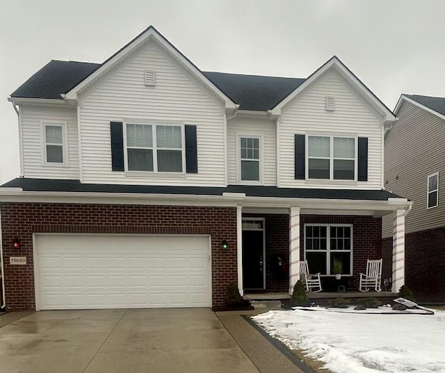 view of front of property with a porch and a garage