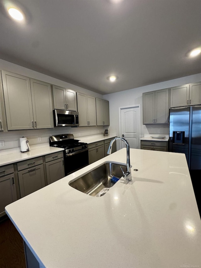 kitchen featuring stainless steel appliances, sink, and gray cabinets