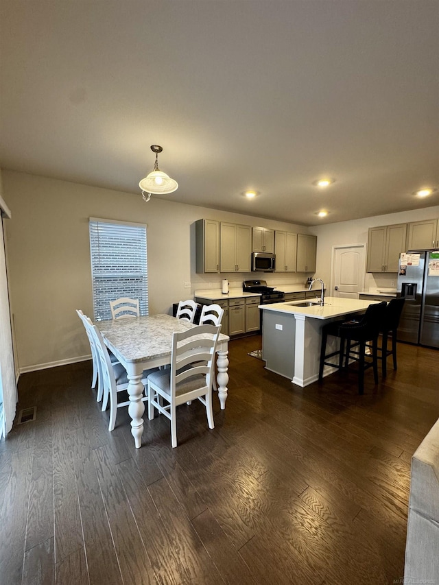 dining area with sink and dark wood-type flooring