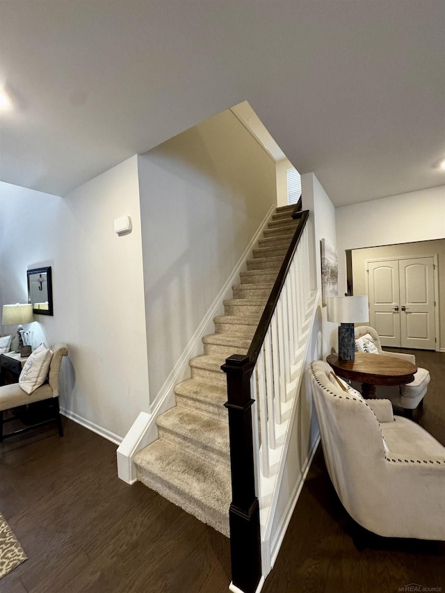 stairs with hardwood / wood-style flooring