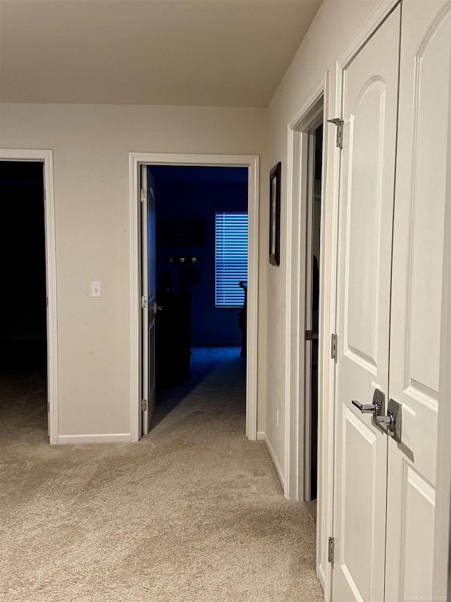 hallway with light colored carpet