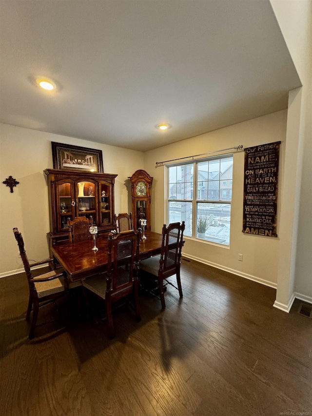 dining space with dark hardwood / wood-style floors