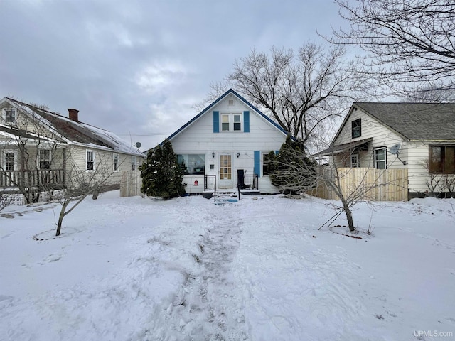 view of snow covered rear of property