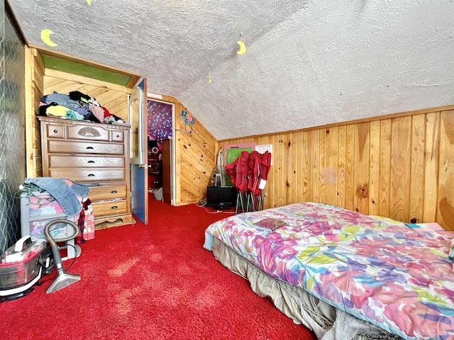 bedroom featuring lofted ceiling, carpet, a textured ceiling, and wooden walls