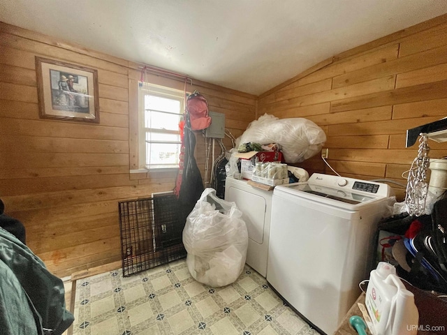 laundry room with separate washer and dryer and wooden walls