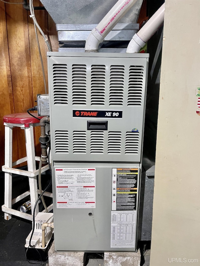 utility room featuring heating unit