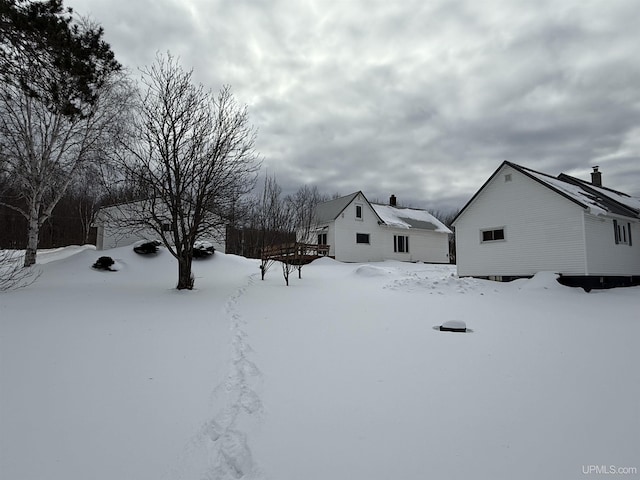 yard layered in snow with a deck