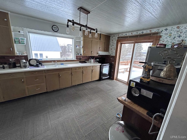 kitchen with sink, decorative light fixtures, black electric range, and backsplash