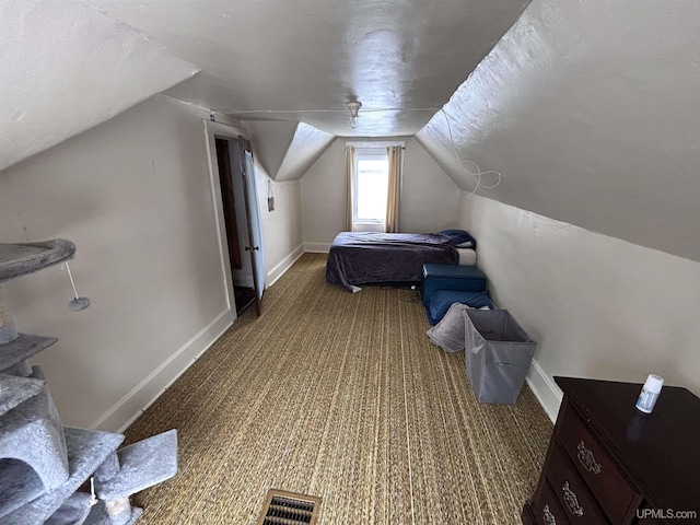 carpeted bedroom with lofted ceiling