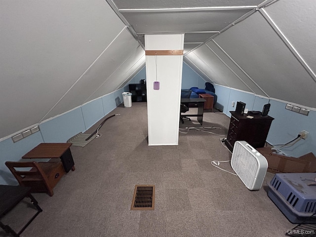 additional living space featuring vaulted ceiling and carpet flooring