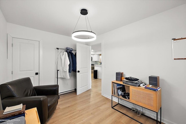 sitting room featuring sink and light hardwood / wood-style floors