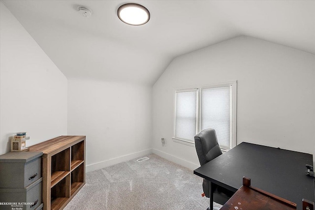 carpeted office space with lofted ceiling