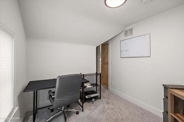 carpeted office with vaulted ceiling