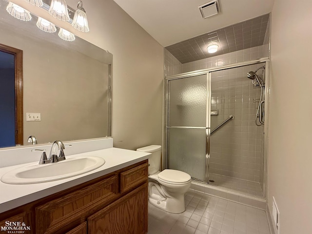 bathroom with vanity, tile patterned floors, toilet, and walk in shower